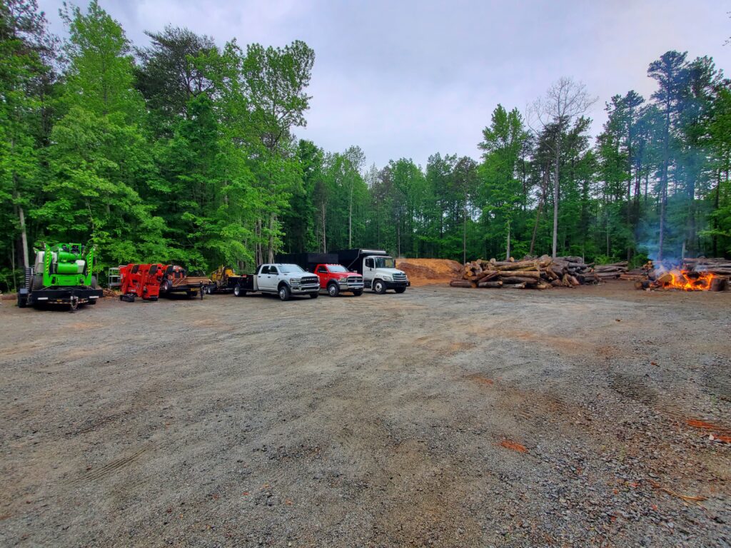 combs tree service trucks at a lot.